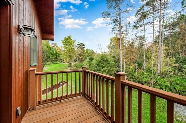 wooden terrace with a lawn