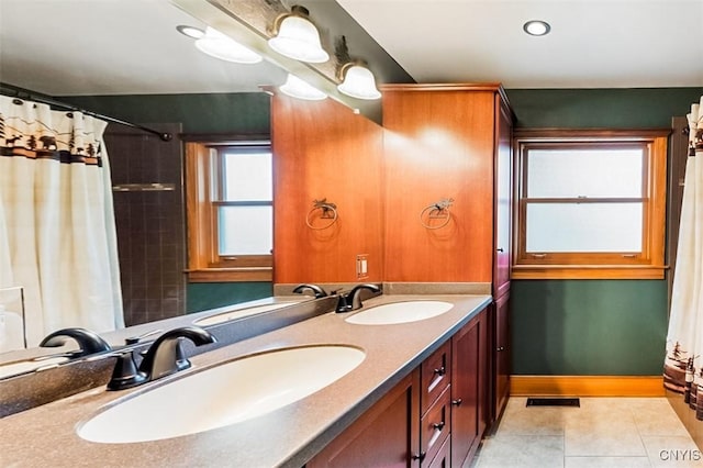 bathroom featuring tile patterned flooring and vanity