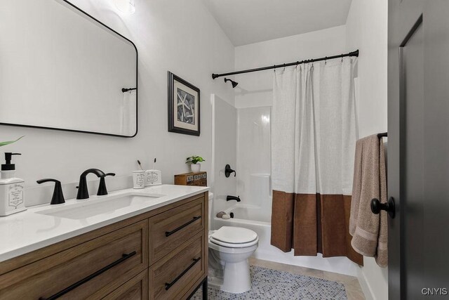 full bathroom with shower / bath combination with curtain, tile patterned floors, vanity, and toilet