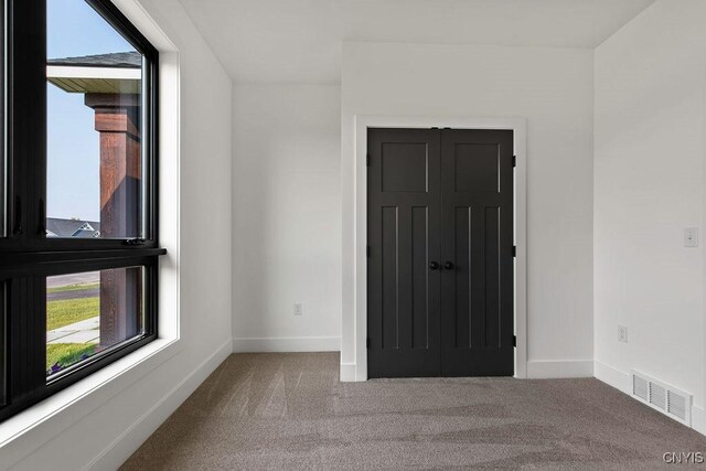 unfurnished room with carpet floors