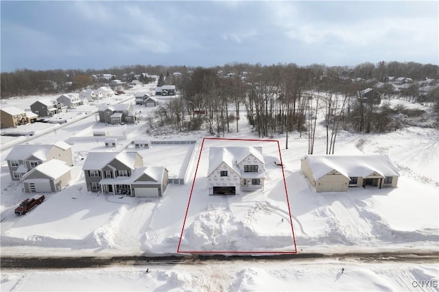 snowy aerial view with a residential view