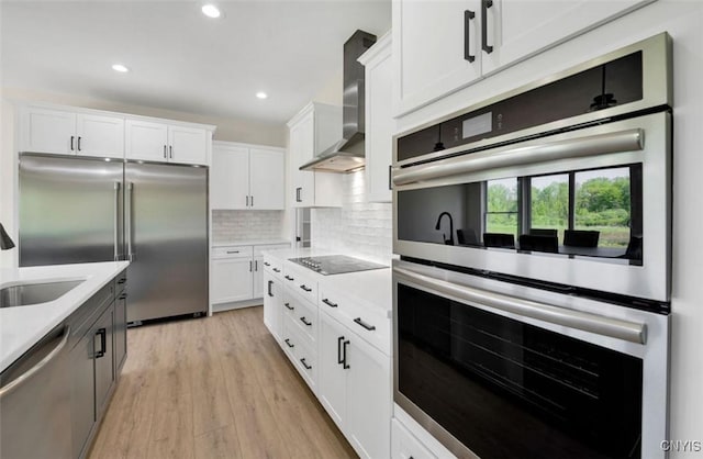 LOT64 Chillingham Way, Lysander, NY 13027 - kitchen with appliances with stainless steel finishes, light countertops, wall chimney exhaust hood, white cabinetry, and recessed lighting
