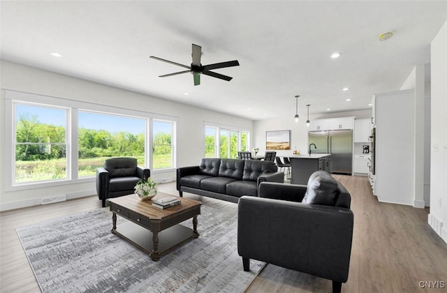 LOT64 Chillingham Way, Lysander, NY 13027 - living area featuring wood finished floors, baseboards, ceiling fan, and recessed lighting
