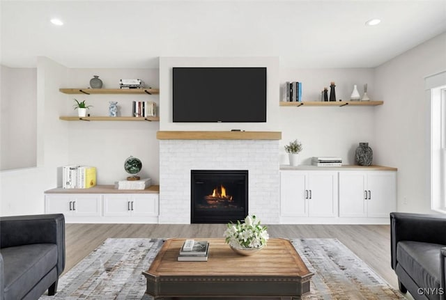 LOT64 Chillingham Way, Lysander, NY 13027 - living room with light wood-style flooring, recessed lighting, and a brick fireplace