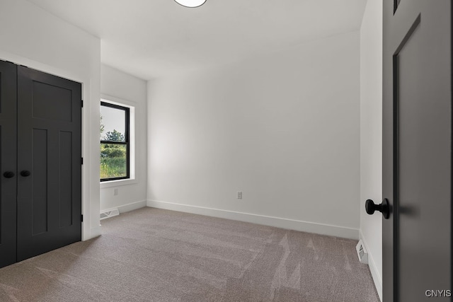 unfurnished bedroom featuring light carpet