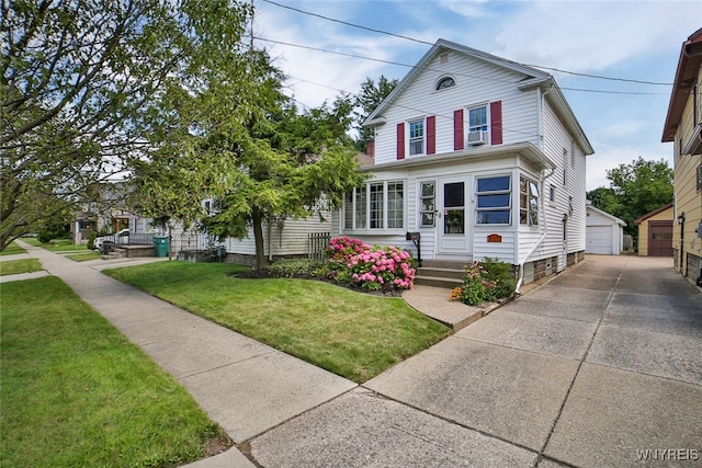 view of front of house with a garage, an outbuilding, and a front lawn