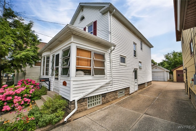 view of side of property featuring a garage and an outdoor structure