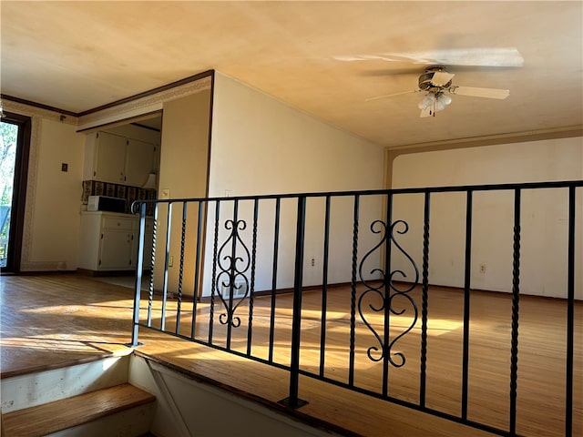 stairway featuring hardwood / wood-style flooring and ceiling fan