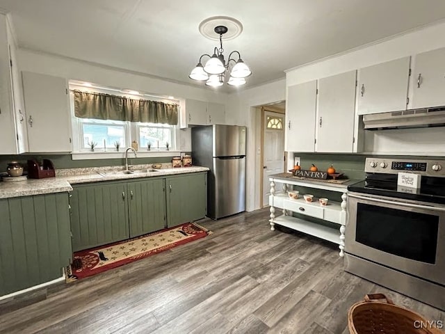 kitchen with wood-type flooring, pendant lighting, sink, and stainless steel appliances