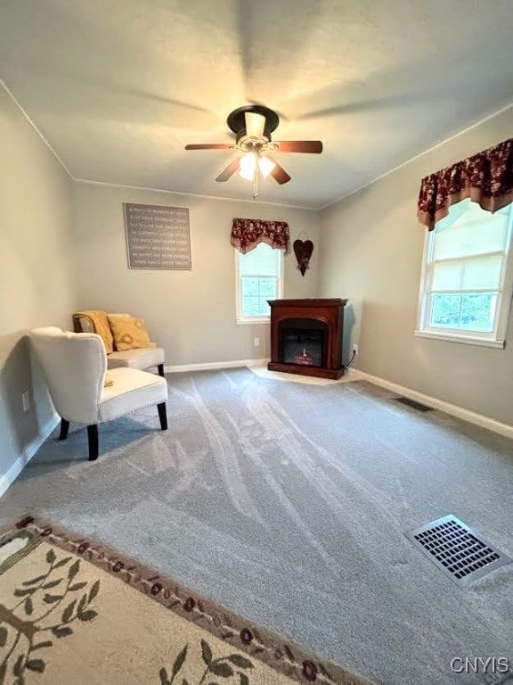 unfurnished room featuring carpet floors, ornamental molding, and ceiling fan