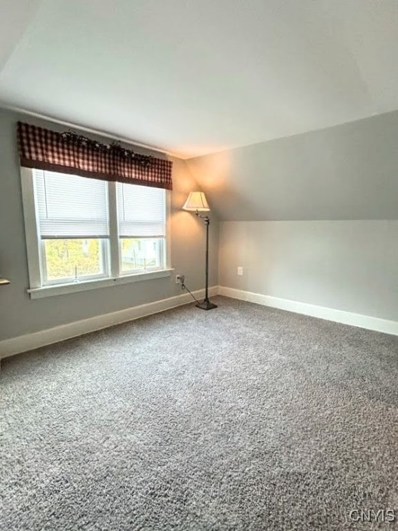 bonus room featuring lofted ceiling and carpet floors