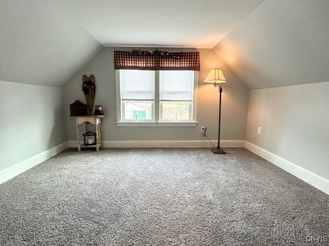 bonus room with lofted ceiling and carpet