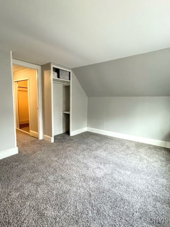 bonus room featuring lofted ceiling and carpet flooring