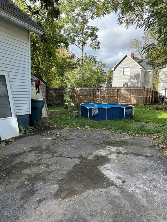 view of patio / terrace with a fenced in pool