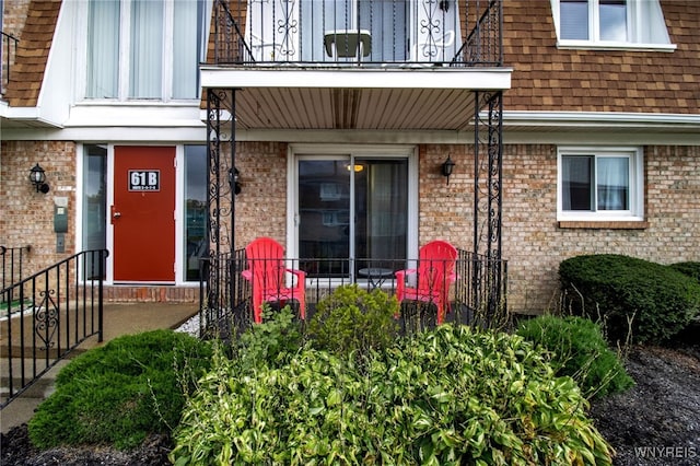 view of exterior entry with a balcony