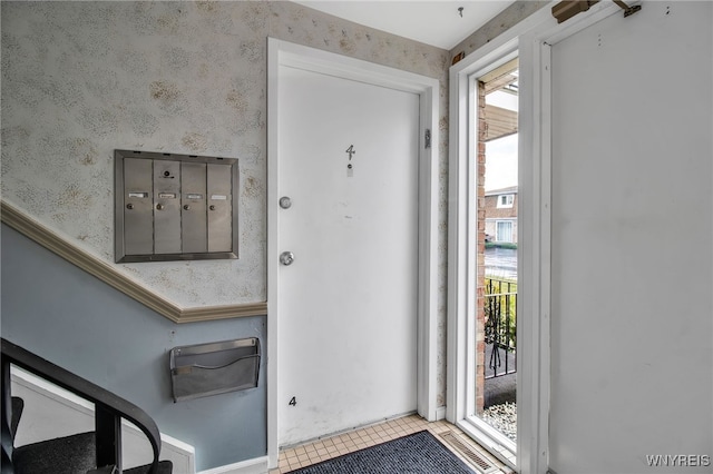 doorway with light tile patterned flooring