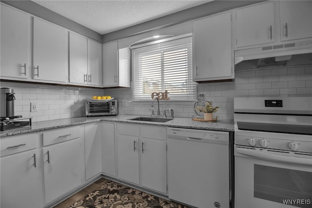 kitchen with range, decorative backsplash, sink, white cabinetry, and dishwasher