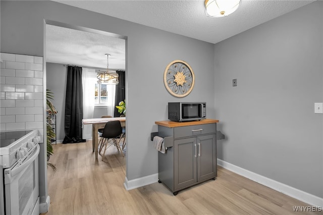 interior space featuring light hardwood / wood-style flooring and a textured ceiling