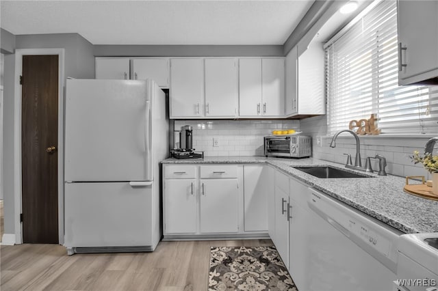 kitchen featuring light hardwood / wood-style flooring, sink, white appliances, and white cabinetry