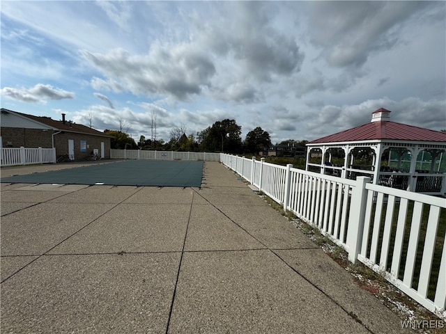 view of swimming pool with a gazebo and a patio area