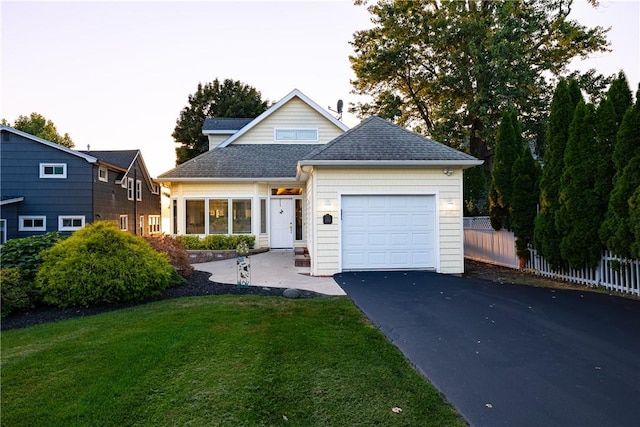 view of front of home featuring a garage and a front yard