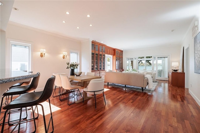 dining space with recessed lighting, crown molding, baseboards, and wood finished floors