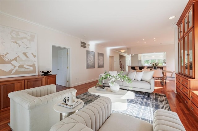 living area with stairway, baseboards, dark wood-type flooring, and ornamental molding