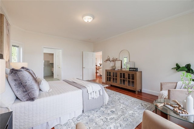 bedroom with crown molding, baseboards, and wood finished floors