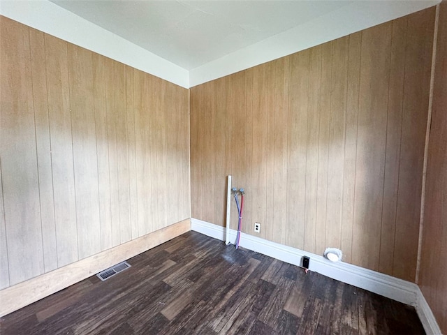 empty room featuring dark hardwood / wood-style flooring