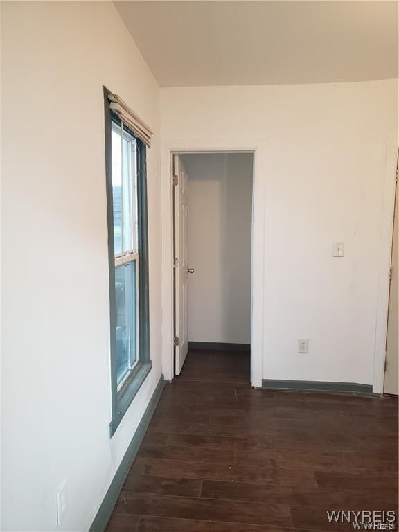 hallway with dark hardwood / wood-style floors