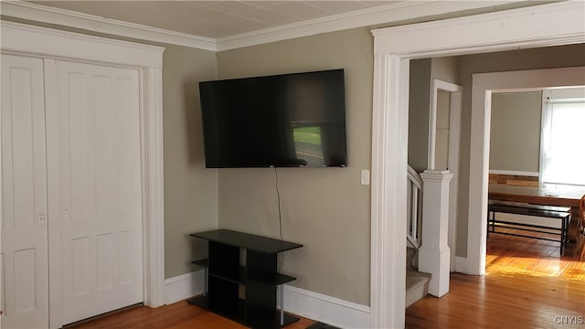 living room featuring crown molding and hardwood / wood-style flooring