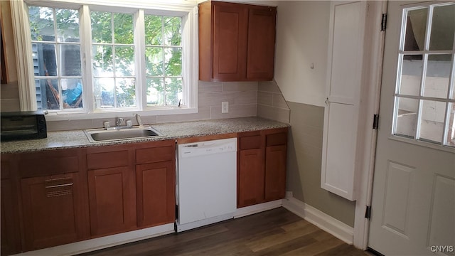 kitchen with dark wood-type flooring, tasteful backsplash, sink, and white dishwasher