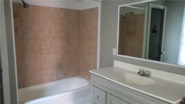 bathroom featuring vanity and tiled shower / bath