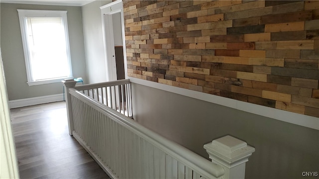 corridor with hardwood / wood-style flooring