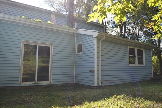 view of home's exterior with a yard