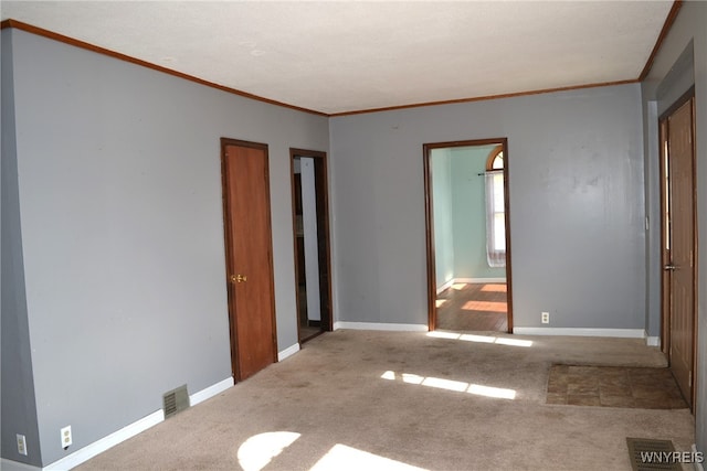 unfurnished bedroom featuring ornamental molding and light colored carpet