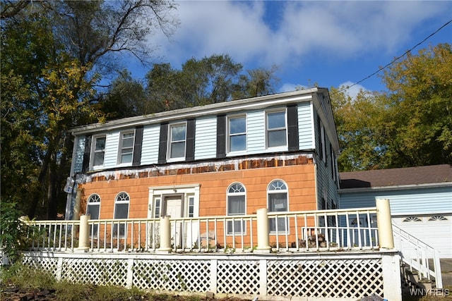 view of front of property with a garage and a wooden deck