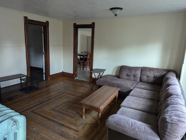 living room featuring dark parquet flooring