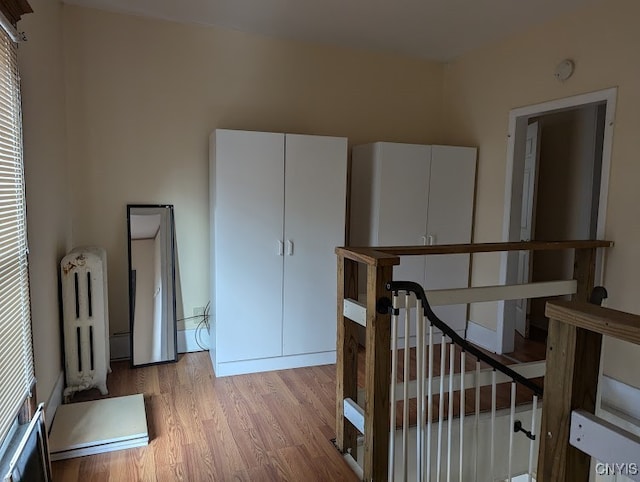 hall featuring radiator and light hardwood / wood-style flooring