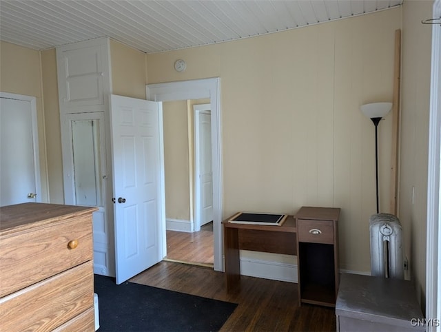 bedroom with dark hardwood / wood-style flooring