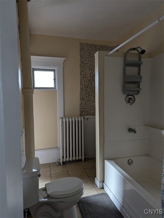 bathroom featuring shower / bath combination, tile patterned floors, radiator, and toilet