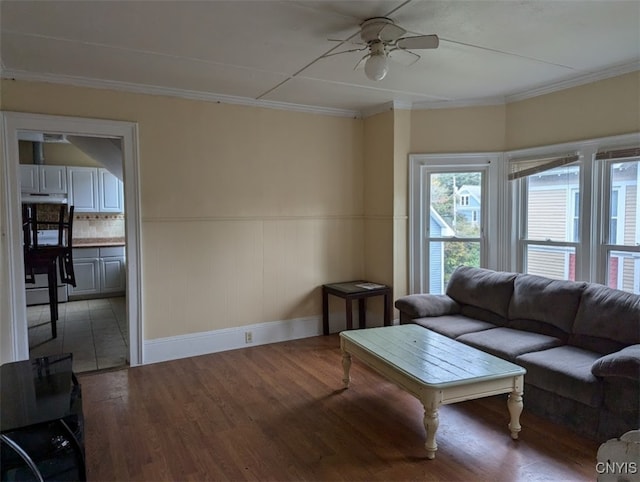 living room featuring ceiling fan, hardwood / wood-style flooring, and crown molding