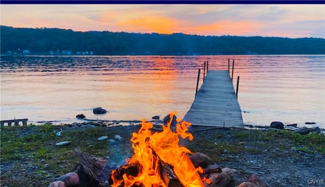 dock area featuring a water view and a fire pit