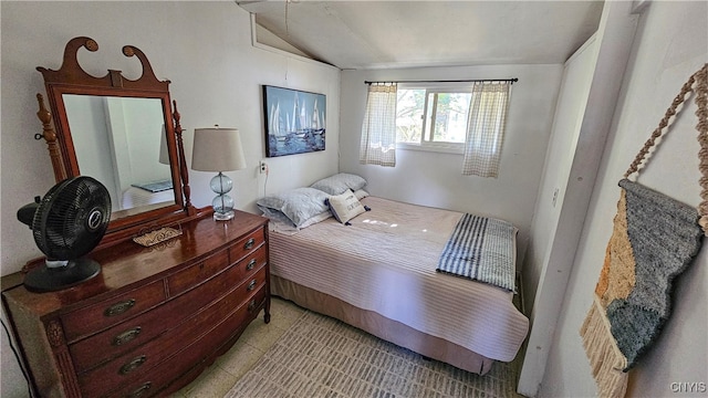 tiled bedroom featuring vaulted ceiling