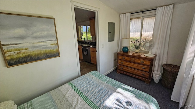 carpeted bedroom with electric panel, sink, and ensuite bath