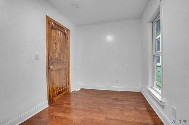 empty room with hardwood / wood-style floors