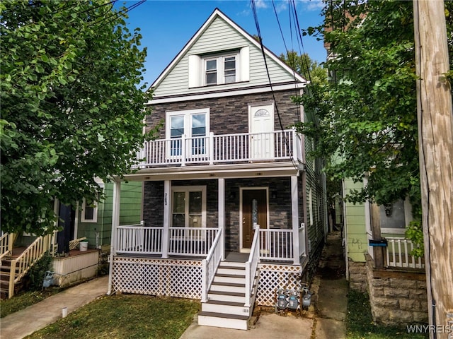 767 W Ave, Buffalo, NY 14213 - view of front facade featuring covered porch, a balcony, stone siding, and stairs