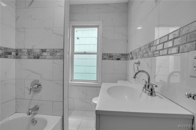 full bathroom featuring toilet, vanity, and tiled shower / bath