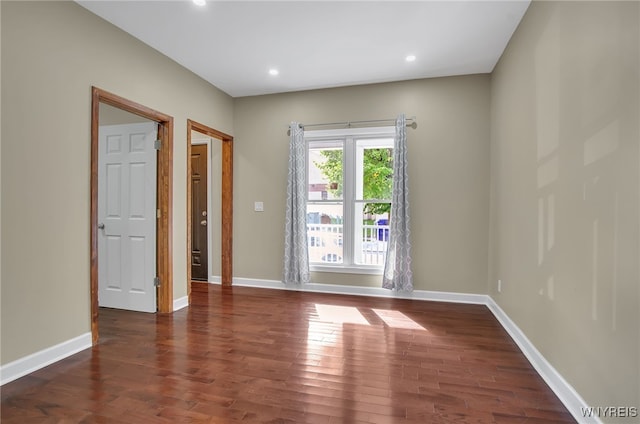 spare room with dark wood-type flooring