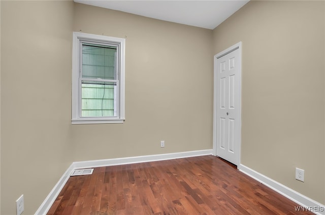 unfurnished room with dark hardwood / wood-style floors